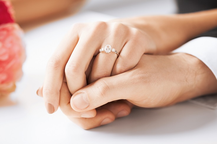 engaged couple holding hands